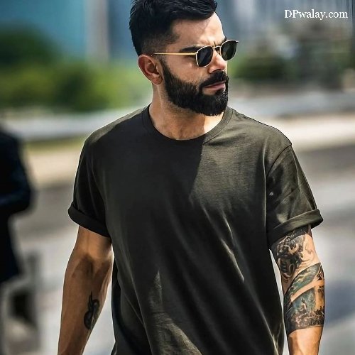 man with beard and sunglasses walking down the street
