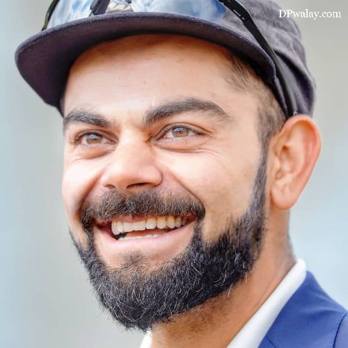 man with beard and hat smiles virat kohli dp