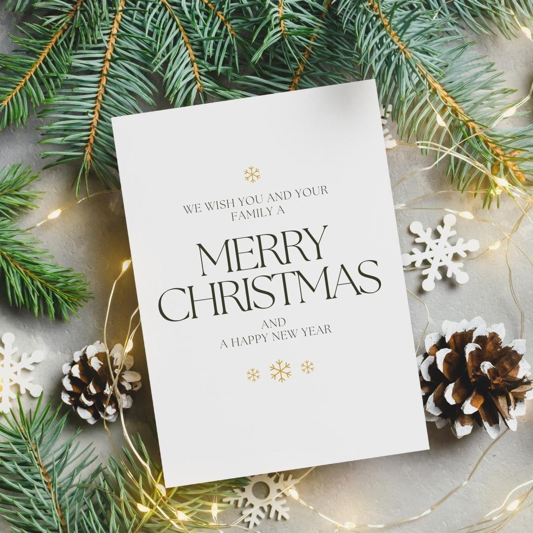 white christmas card with gold foil lettering and pine branch